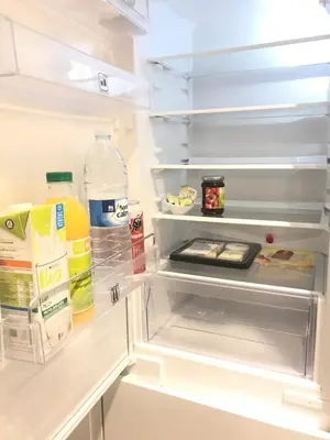 an open refrigerator filled with food and drinks at Les lofts de Styliste in Brussels