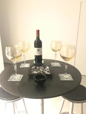 a bottle of wine sitting on a table with wine glasses at Les lofts de Styliste in Brussels