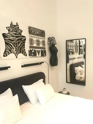 a bedroom with a bed and some pictures on the wall at Les lofts de Styliste in Brussels