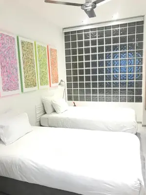 two white beds in a room with a window at Les lofts de Styliste in Brussels