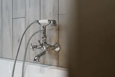 a shower head on top of a sink in a bathroom at Casa Lavanda in Zottegem
