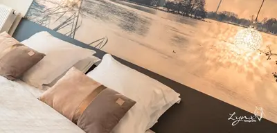a bed with pillows and a painting on the wall at De Vesten Comfort Lodge in Laakdal