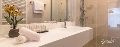 a white bathroom with a sink and a shower at De Vesten Comfort Lodge in Laakdal