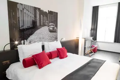 a bedroom with a large bed with red pillows at Zimmerhof Hotel in Lier