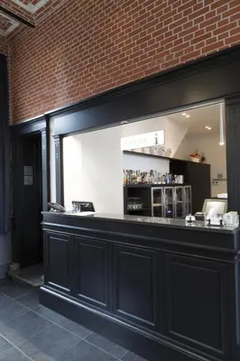 a bar in a restaurant with a brick wall at Zimmerhof Hotel in Lier