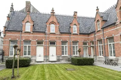 a large brick building with a grass yard at Zimmerhof Hotel in Lier