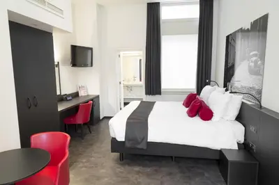 a hotel room with a bed and a table and chairs at Zimmerhof Hotel in Lier