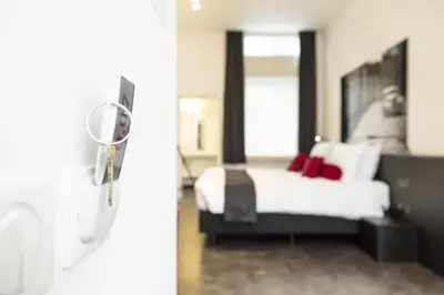 a bedroom with a bed and a mirror at Zimmerhof Hotel in Lier