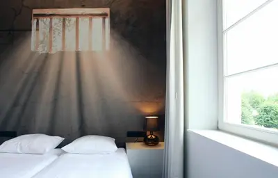 a bedroom with two beds and a window at Hotel The Lodge Vilvoorde in Vilvoorde