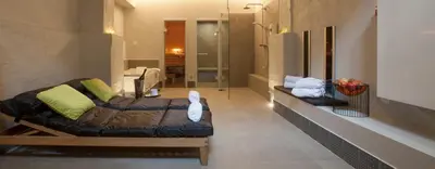 a living room with a couch in a room at Hotel The Lodge Vilvoorde in Vilvoorde