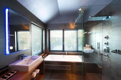 a bathroom with a tub and a sink and a shower at Suite & B by Hofke van Bazel in Bazel