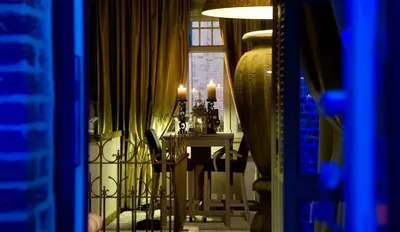 a dining room with a table and a window at Suite & B by Hofke van Bazel in Bazel
