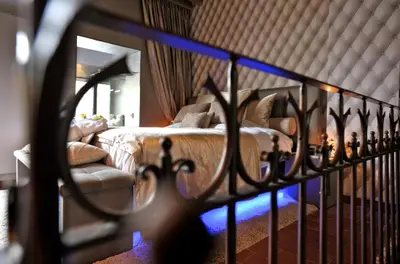 a bedroom with a bed and a mirror at Suite & B by Hofke van Bazel in Bazel