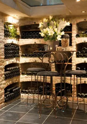 a wine cellar with a table and chairs and wine bottles at Suite & B by Hofke van Bazel in Bazel