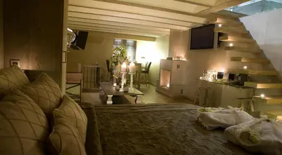 a living room with a bed and a dining room at Suite & B by Hofke van Bazel in Bazel