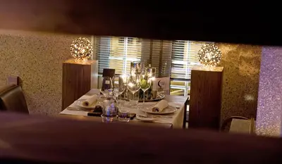 a table with glasses and wine bottles on it at Suite & B by Hofke van Bazel in Bazel