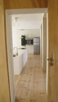 a hallway of a kitchen with a sink and a counter at Huize Maeterlinck in Ghent