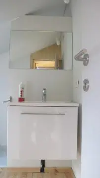 a bathroom with a white sink and a mirror at Huize Maeterlinck in Ghent