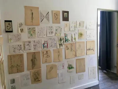 a wall with drawings of people on it at Huize Maeterlinck in Ghent