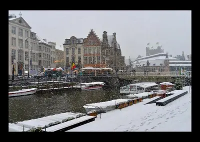 a city covered in snow with buildings and a river at Rooms With A View in Ghent