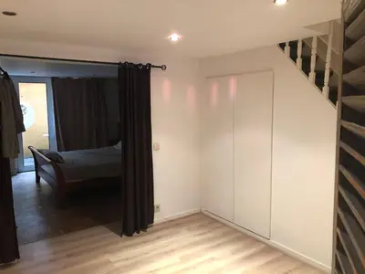 a bedroom with a bed and a stair case at Brugman in Brussels
