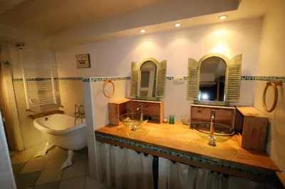 a bathroom with a tub and a sink and a toilet and a bath tub at Brugman in Brussels