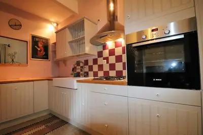 a kitchen with white cabinets and a microwave at Brugman in Brussels