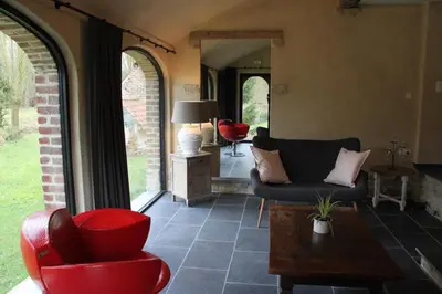 a living room with two chairs and a table at Logies Tommenmolen in Grimbergen