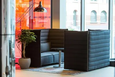 a waiting room with a couch and a table at Park Inn by Radisson Leuven in Leuven