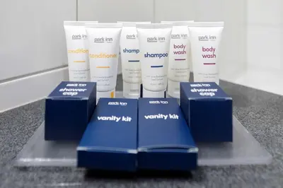 a group of white and blue products on a counter at Park Inn by Radisson Leuven in Leuven