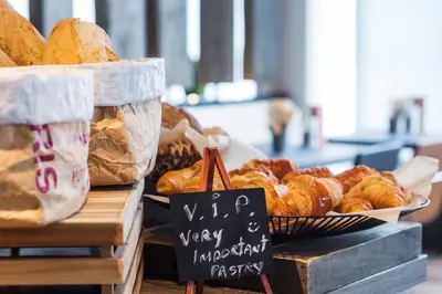 a display of bread and pastries on a table at Park Inn by Radisson Leuven in Leuven