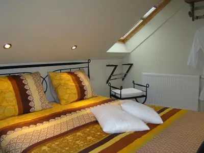 a bedroom with two beds with pillows at B&B Sogni d'oro in Lovendegem