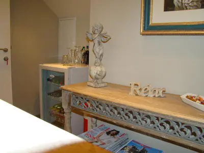 a wooden table with a statue on top of it at B&B Sogni d'oro in Lovendegem