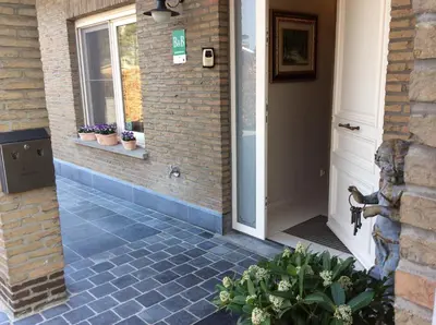 a front door of a house with potted plants at B&B Sogni d'oro in Lovendegem