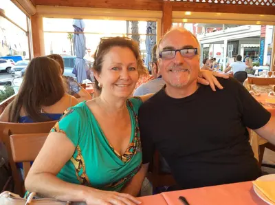 a man and woman sitting at a table in a restaurant at B&B Sogni d'oro in Lovendegem