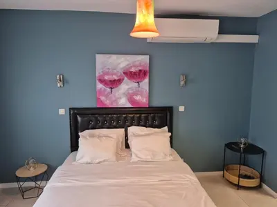 a bedroom with a bed with a painting of wine glasses at Dokstudio50 in Ghent