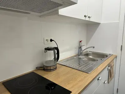 a kitchen counter with a sink and a mixer at Dokstudio50 in Ghent