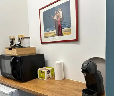 a microwave on a counter with a picture on the wall at Dokstudio50 in Ghent