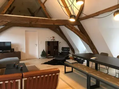 a living room with a table and a dining room at Living The Dream in Ghent