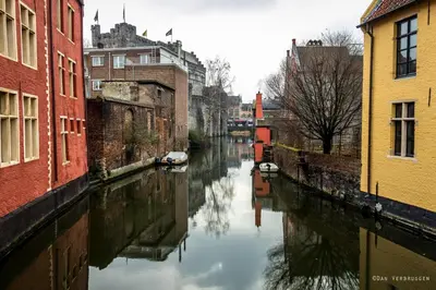 a canal in a city with buildings next to a river at Living The Dream in Ghent