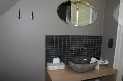 a bathroom with a sink and a mirror on the wall at B&B de Rijcke Rust in Rijkevorsel