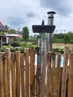 a bird feeder attached to a wooden fence at B&B de Rijcke Rust in Rijkevorsel