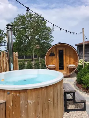 a hot tub in a garden with a circular building at B&B de Rijcke Rust in Rijkevorsel