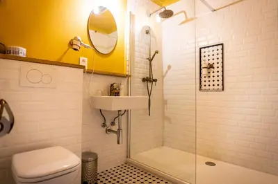 a bathroom with a shower and a toilet and a sink at Flandria Hotel Gent Centrum in Ghent