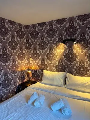 a bedroom with a bed with two towels on it at Flandria Hotel Gent Centrum in Ghent