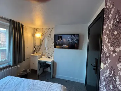a hotel room with a bed and a sink at Flandria Hotel Gent Centrum in Ghent