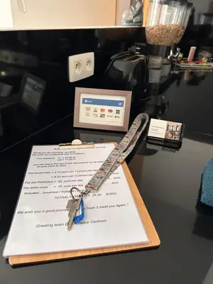 a table with a sheet of paper with a key on it at BnB Antwerp Centrum in Antwerp