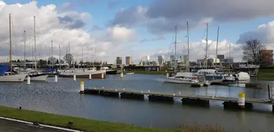 a group of boats docked at a dock in a harbor at BnB Antwerp Centrum in Antwerp