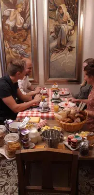 a group of people sitting around a table with food at B&B Bon-Bon 'nuit' in Turnhout