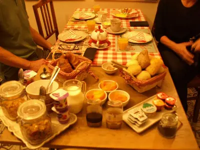 a table with food and people sitting around it at B&B Bon-Bon 'nuit' in Turnhout